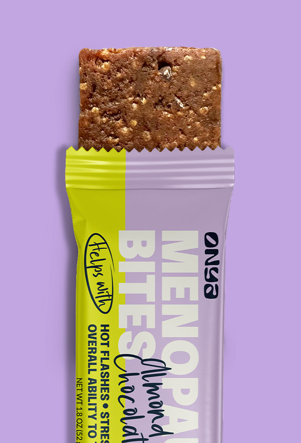 Almond Butter Chocolate chip ONYA bar opened with wrapper on lavender background.